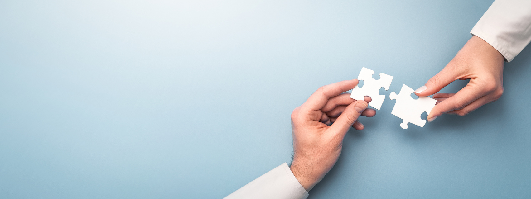 People Holding Jigsaw Pieces